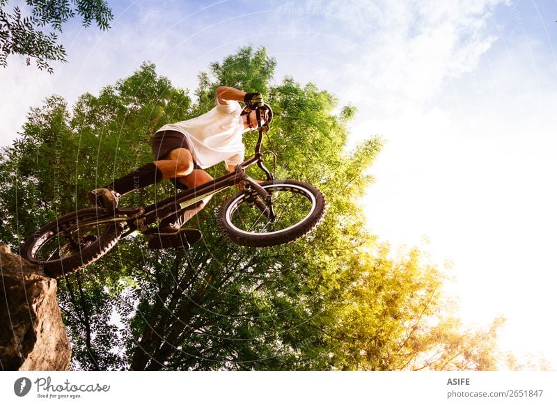 Young cyclist on the edge of a rock ready to jump Freedom Summer Mountain Sports Cycling Man Adults Nature Tree Forest Rock Jump Strong Rider bike Extreme