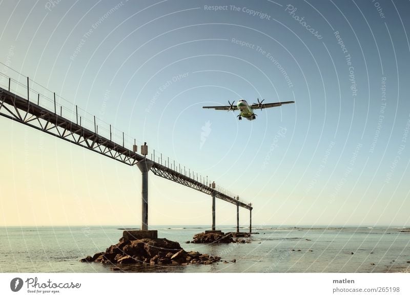 scheduled flight Cloudless sky Ocean Means of transport Aviation Airplane Passenger plane Propeller aircraft Airport Blue Green approach Control system