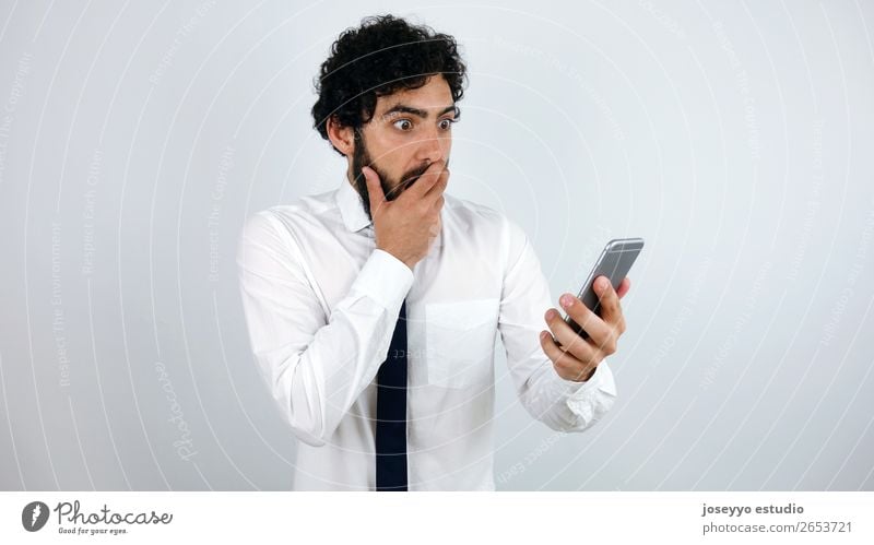 Business man with mobile phone in his hand Amazed Beard Businessman To call someone (telephone) Cellphone Communication Expression Face Forget Hand Internet