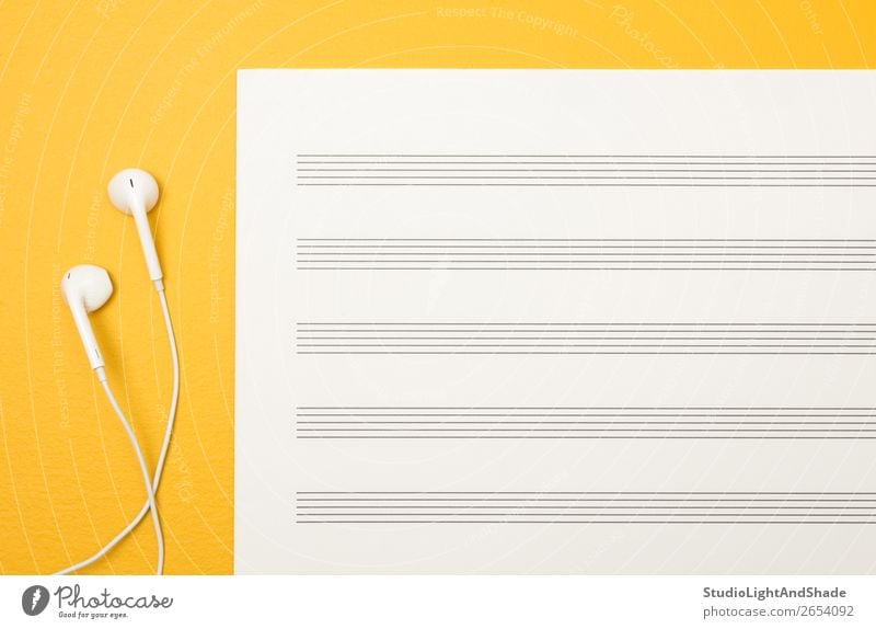 Earphones and blank music sheet on yellow background Design Joy Happy Music Art Musical notes Paper Simple Bright Modern Yellow White Colour Creativity