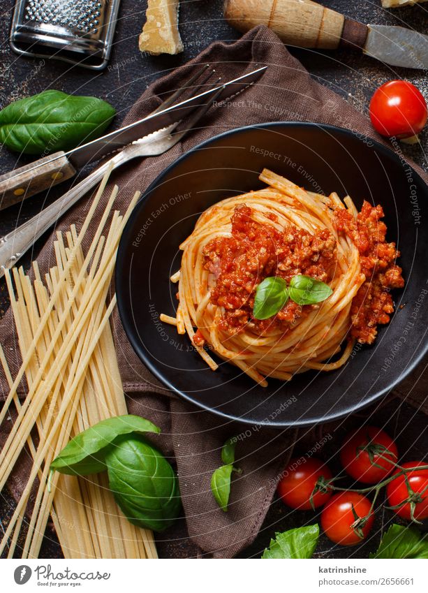 Spaghetti pasta with bolognese sauce Meat Cheese Herbs and spices Lunch Dinner Plate Fork Wood Bright Above Tradition Basil Beef Bolognese Cooking Dish food