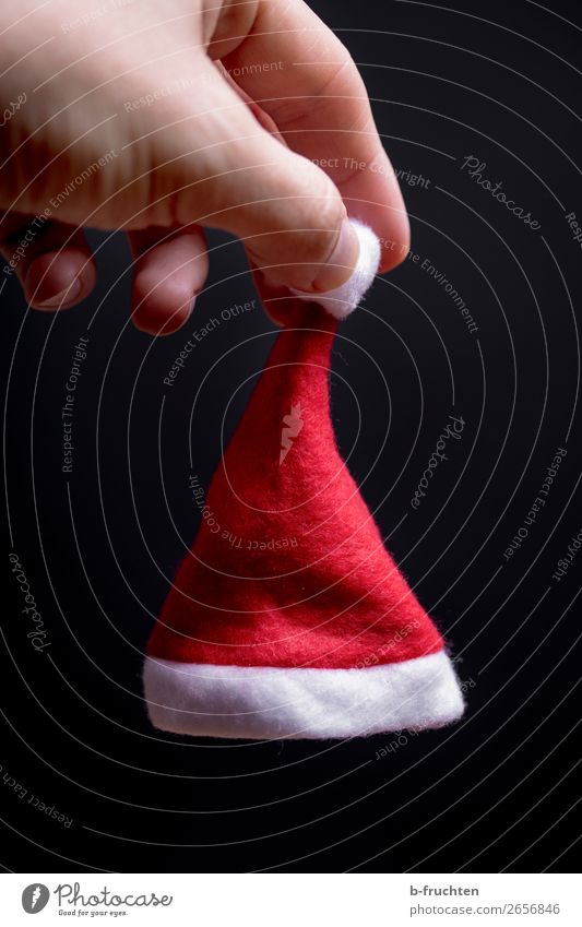 small christmas cap in the hand Lifestyle Entertainment Feasts & Celebrations Christmas & Advent Man Adults Hand Fingers Cap Utilize To hold on Red Black
