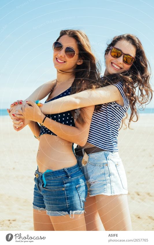 Female friends on the beach Lifestyle Joy Happy Beautiful Vacation & Travel Tourism Summer Beach Ocean Woman Adults Friendship Sand Bikini Sunglasses Smiling