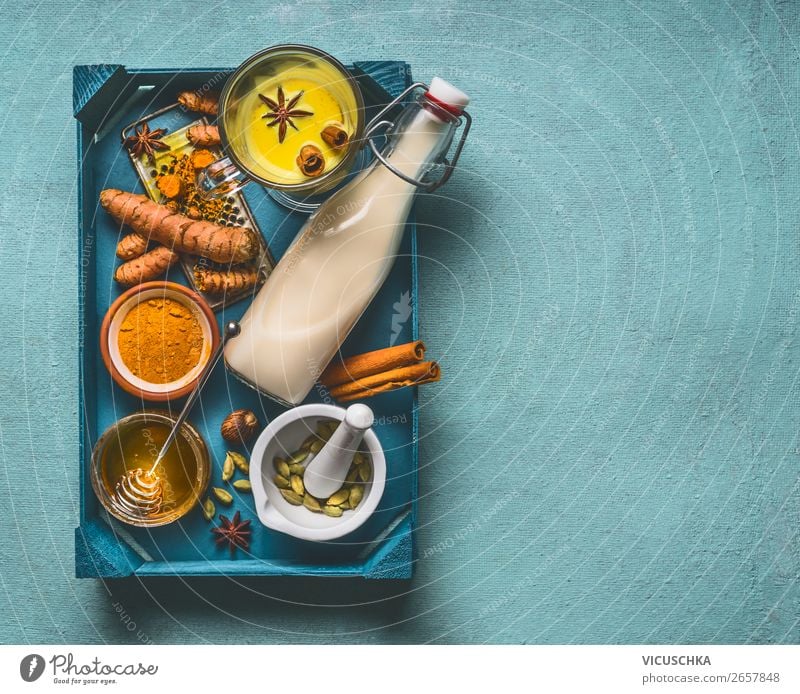 Golden turmeric milk on tray with ingredients Food Herbs and spices Nutrition Organic produce Vegetarian diet Diet Beverage Hot drink Crockery Cup Mug Bottle