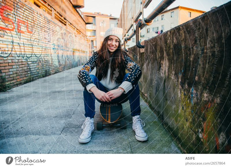 Skater woman sitting on longboard Lifestyle Style Joy Happy Beautiful Leisure and hobbies Winter Sports Woman Adults Youth (Young adults) Culture Autumn Street