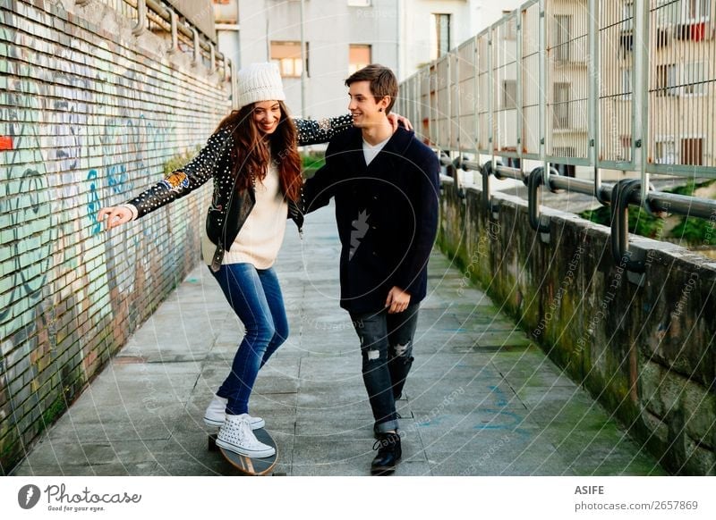 Funny couple learning to skate Lifestyle Style Joy Happy Beautiful Winter Sports School Woman Adults Man Couple Youth (Young adults) Culture Autumn Street
