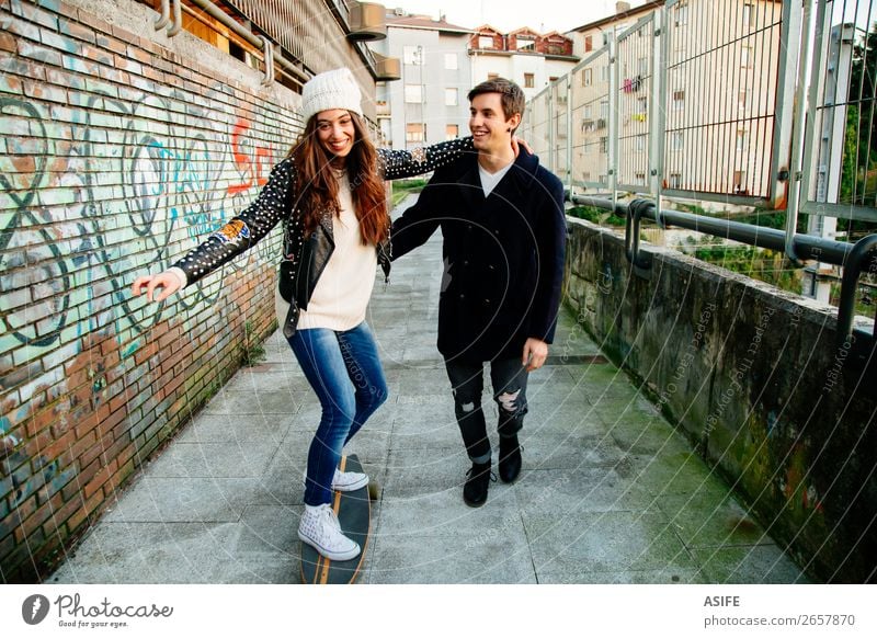 Funny couple learning to skate Lifestyle Style Joy Happy Beautiful Winter Sports School Woman Adults Man Couple Youth (Young adults) Culture Autumn Street