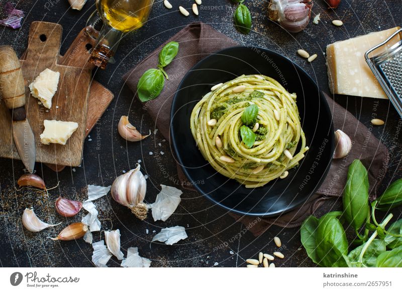 Spaghetti pasta with pesto sauce Cheese Herbs and spices Lunch Dinner Vegetarian diet Diet Fork Leaf Dark Fresh Above Green Black Tradition Basil cooking