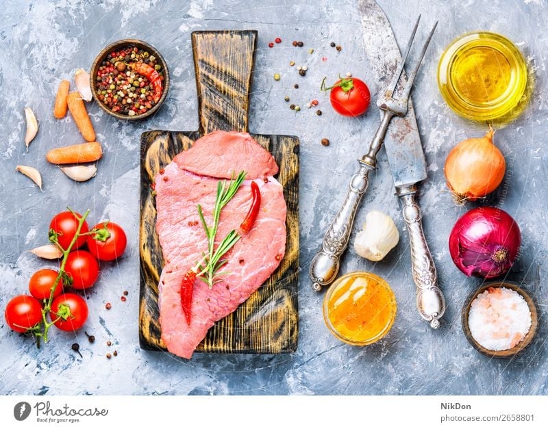 Raw beef meat raw food steak fresh cut red chop uncooked butcher fork spice rosemary pepper fillet herb protein slice sirloin meal seasoning beefsteak veal