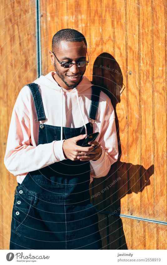 Young black man using smart phone outdoors - a Royalty Free Stock Photo ...