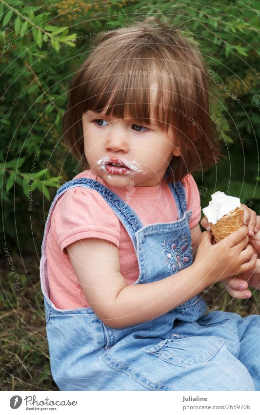 Cute girl are eating icecream Ice cream Eating Drinking Garden Child Baby Woman Adults Park Blonde White kid European Caucasian one two three Lady short hair