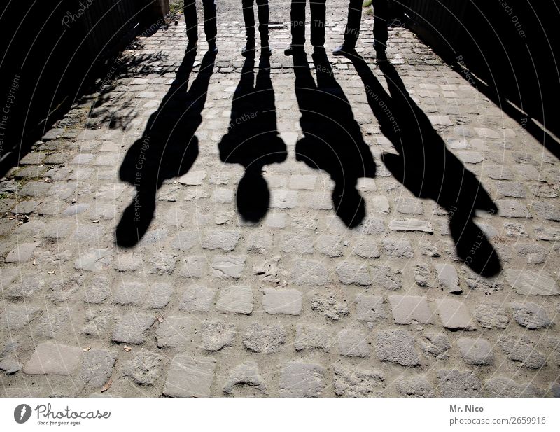 shadow of a man Masculine 4 Human being Stand Paving stone Black Shadow play Posture Abstract Group Contrast Silhouette Light Gray Lighting effect Exceptional