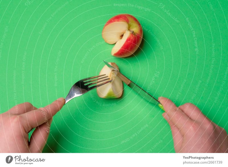 Cutting apple on a green table. Diet food. Fruit Apple Eating Vegetarian diet Cutlery Lifestyle Healthy Eating Table Kitchen Fresh Green above view apple fruit