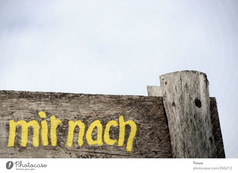 Wooden sign with inscription "mir nach" (after me) Sky Characters Signage Warning sign Old Blue Brown Yellow Gray Weathered Signs and labeling Word Colour photo