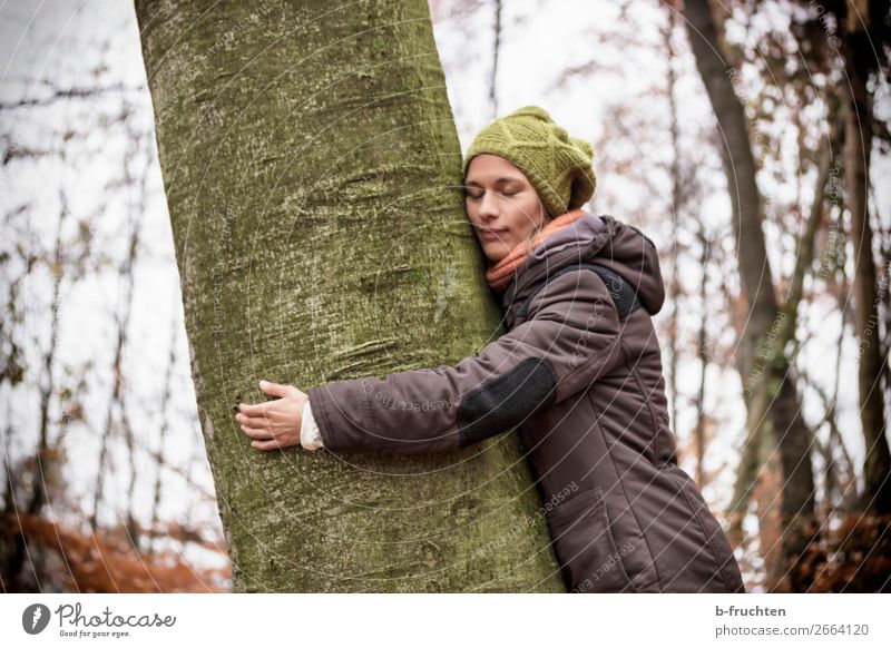 Woman with knitted hat and coat hugs a tree, dreaming in nature. Harmonious Well-being Senses Relaxation Calm Meditation Hiking Adults Face sleeves 1