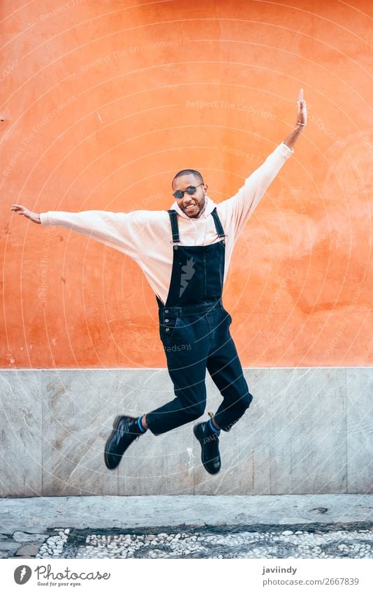Young black man wearing casual clothes jumping in urban background. Lifestyle Joy Happy Beautiful Human being Masculine Young man Youth (Young adults) Man
