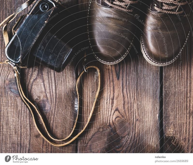 leather brown shoes and an old vintage camera Style Design Camera Feet Fashion Clothing Leather Footwear Wood Old Brown Top Vantage point Classic background