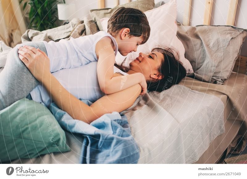 happy mother hugs her toddler son in the morning Lifestyle Joy Relaxation Playing Bedroom Child Toddler Boy (child) Parents Adults Mother Family & Relations