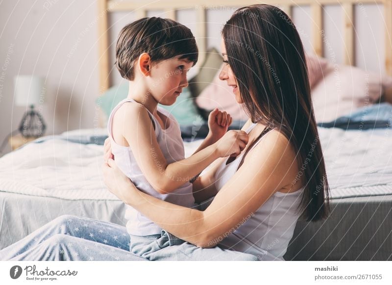 happy mother hugs her toddler son Lifestyle Joy Happy Relaxation Playing Bedroom Child Toddler Boy (child) Parents Adults Mother Family & Relations Infancy