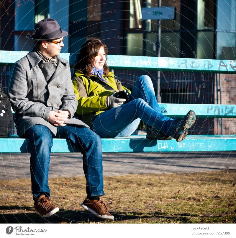 Meeting point new center Woman Man Friendship 2 18 - 30 years 30 - 45 years Meadow Jeans Jacket Footwear Hat Long-haired Park bench Signage Smiling Sit