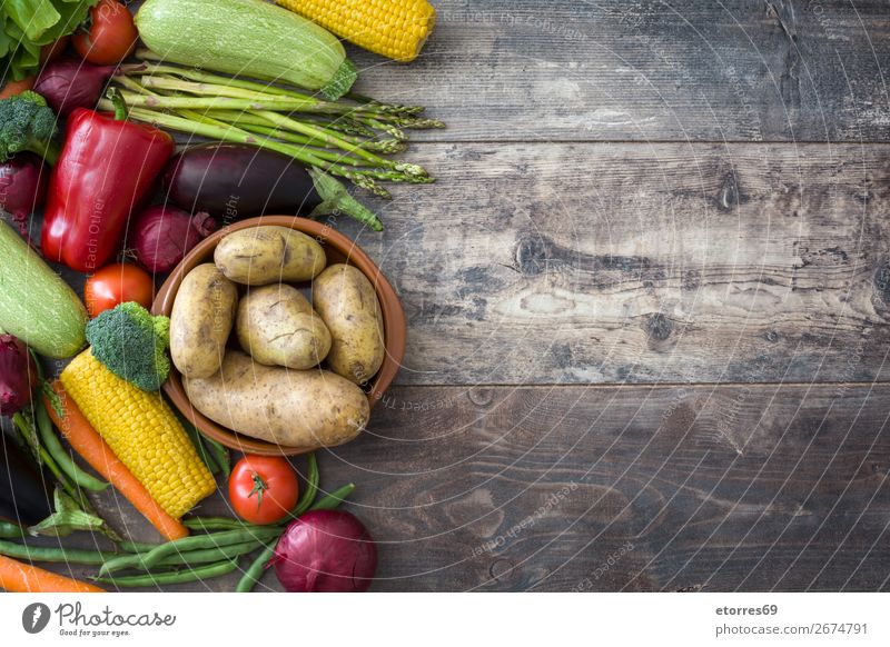 Vegetables and fruit on wood Food Healthy Eating Food photograph Fruit Nutrition Vegetarian diet Diet Multicoloured Yellow Green Red Zucchini Tomato Maize Onion