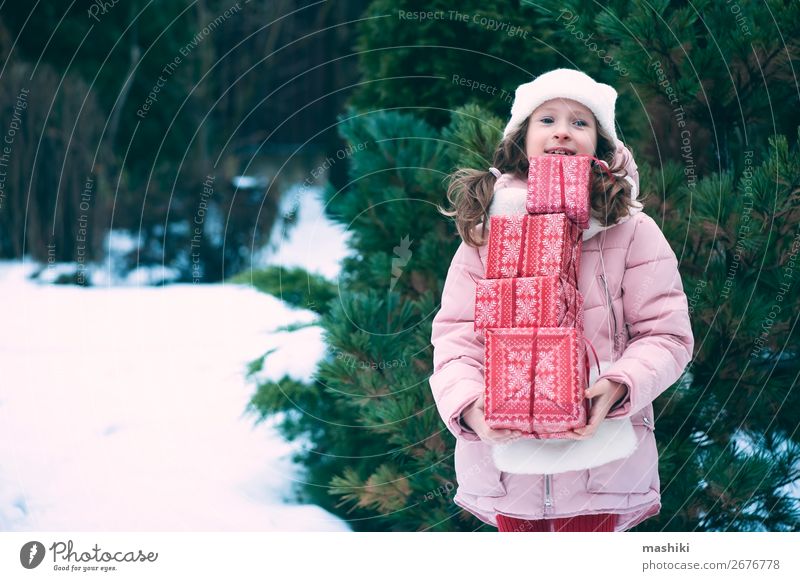 happy kid girl playing outdoor with christmas gifts Lifestyle Joy Happy Playing Vacation & Travel Winter Snow Feasts & Celebrations Christmas & Advent Child