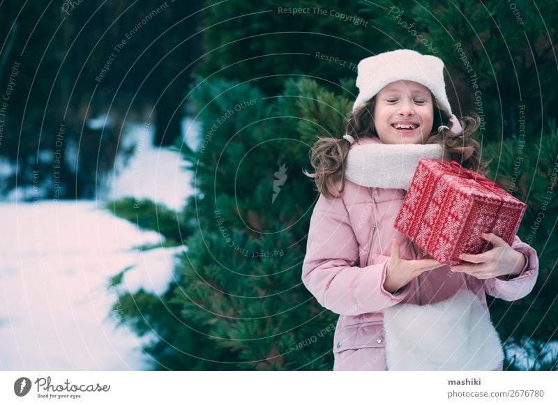 happy kid girl playing outdoor with christmas gifts Lifestyle Joy Happy Playing Vacation & Travel Winter Snow Feasts & Celebrations Christmas & Advent Child