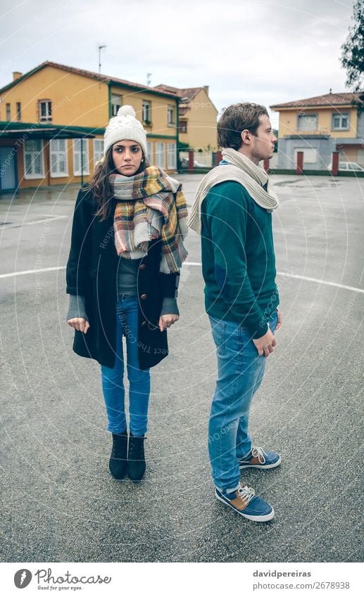 Couple wearing winter clothes standing outdoors in a rainy day Lifestyle Beautiful Relaxation Leisure and hobbies Winter Human being Woman Adults Man Friendship