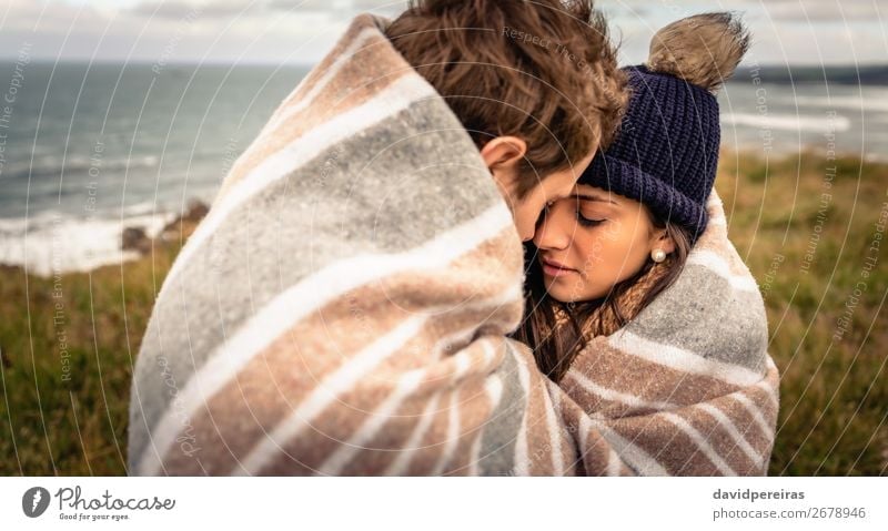 Young couple embracing outdoors under blanket in a cold day Lifestyle Happy Beautiful Ocean Winter Mountain Woman Adults Man Couple Nature Sky Clouds Autumn