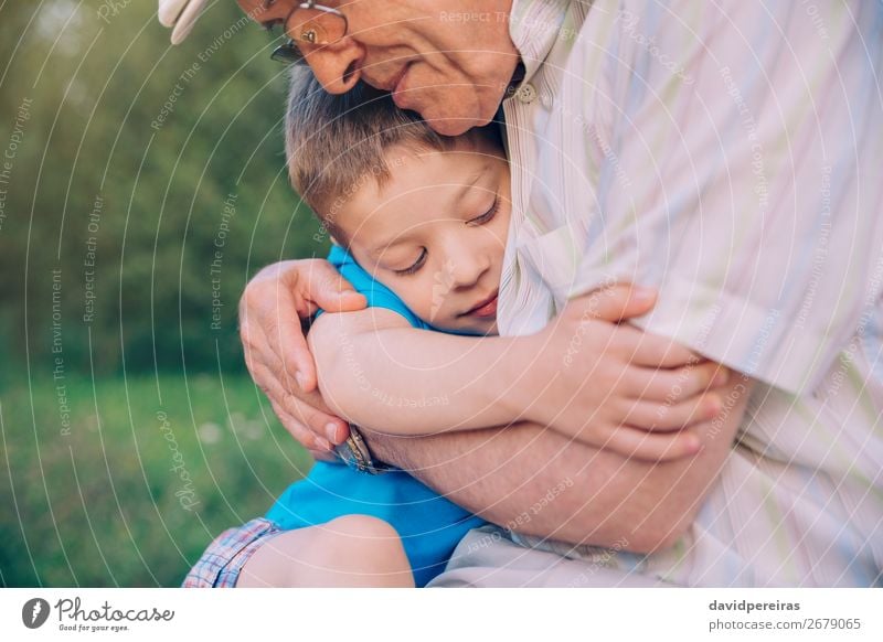 Happy grandson hugging grandfather over a nature outdoor background Lifestyle Relaxation Leisure and hobbies Summer Garden Child Human being Boy (child) Man