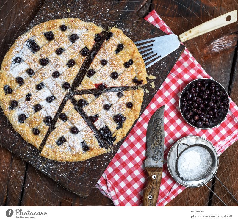 baked round black currant cake cut into pieces Fruit Dough Baked goods Cake Dessert Candy Nutrition Table Wood Fresh Delicious Above Brown Red Black White