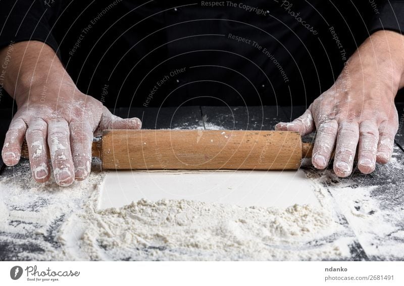 wooden rolling pin in male hands Dough Baked goods Bread Table Kitchen Cook Human being Hand Make Black White Pizza Flour Bakery cooking food Home-made