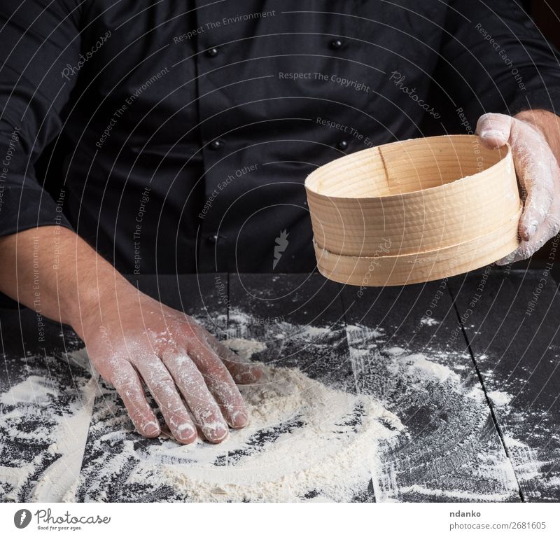 Chef prepares the dough of white flour Dough Baked goods Bread Nutrition Table Kitchen Cook Man Adults Hand Sieve Wood Dark Natural White Flour cooking food