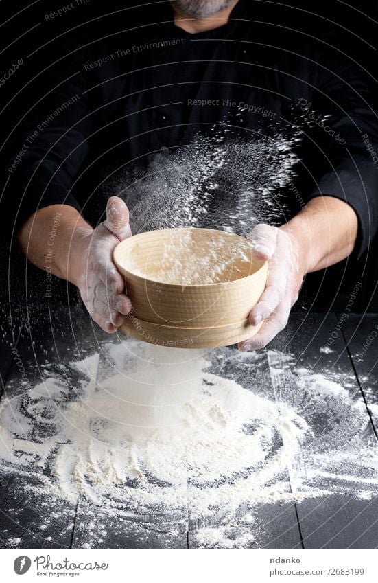 wooden sieve with flour in male hands Dough Baked goods Bread Nutrition Table Kitchen Cook Human being Man Adults Hand 30 - 45 years Sieve Wood Movement Make