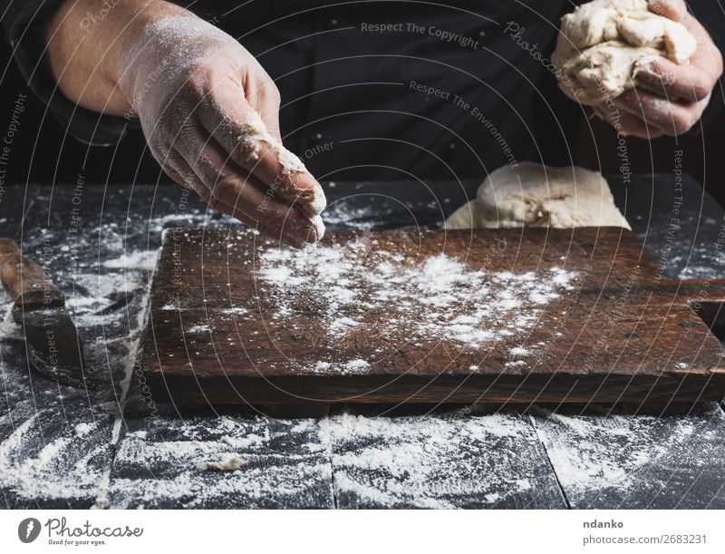 chef in black jacket kneads dough Dough Baked goods Bread Nutrition Skin Table Kitchen Cook Human being Man Adults Hand Wood Make Black White Tradition Baking