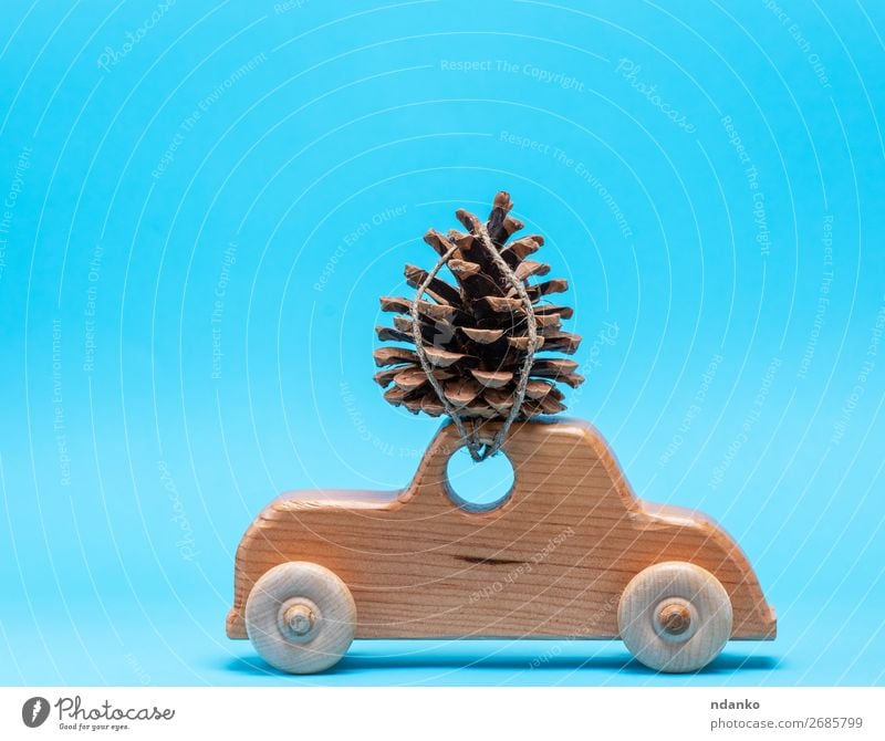 wooden toy car carries on top a pine cone Decoration Feasts & Celebrations Christmas & Advent New Year's Eve Transport Car Toys Wood Movement Retro Blue Brown