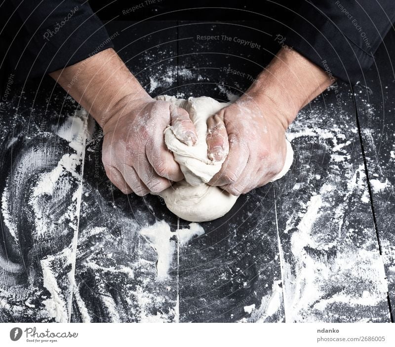 baker kneads white wheat flour dough Dough Baked goods Bread Nutrition Table Kitchen Cook Man Adults Hand Wood Make Black White Tradition prepare Baking Baker