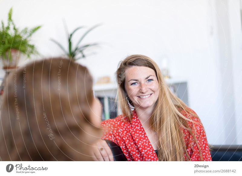 Two friends talking and laughing on a sofa in the living room at home Beautiful Calm Flat (apartment) Meeting To talk Human being Feminine Young woman