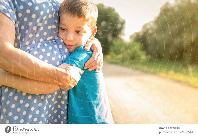 Grandson hugging to his grandmother outdoors Lifestyle Happy Relaxation Leisure and hobbies Summer Garden Child Human being Boy (child) Woman Adults Man Parents