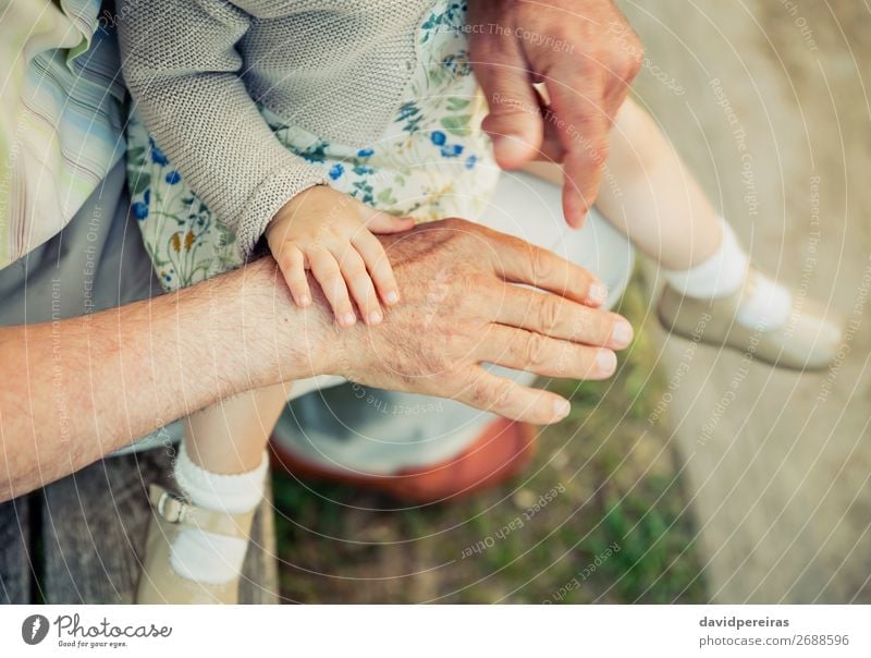 Baby girl touching hand of senior man Skin Life Child Retirement Human being Woman Adults Man Grandfather Family & Relations Hand Nature Old Touch Love