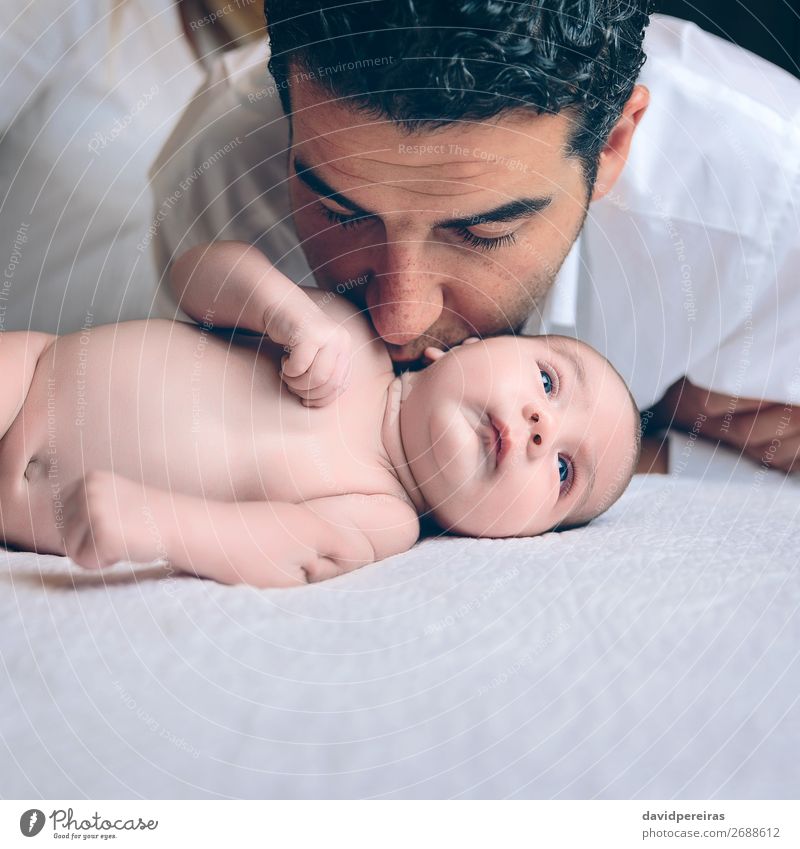 Man kissing to peaceful newborn lying over bed Lifestyle Joy Happy Beautiful Leisure and hobbies Bedroom Child Human being Baby Toddler Boy (child) Adults