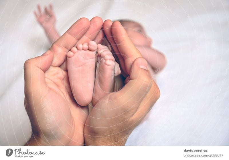 Father hands holding feet of newborn lying over bed Beautiful Skin Life Bedroom Child Human being Baby Parents Adults Family & Relations Infancy Hand Fingers