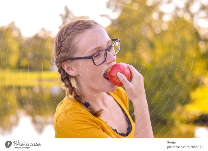 Young woman bites an apple Food Apple Eating Lifestyle Joy Healthy Healthy Eating Well-being Summer Feminine Youth (Young adults) 1 Human being 13 - 18 years