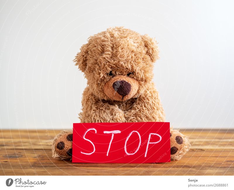 Child abuse - Teddy bear with a red stop sign Parenting Piece of paper Stop sign Sign Sit Emotions Bravery Self-confident Willpower Protection Attentive Concern