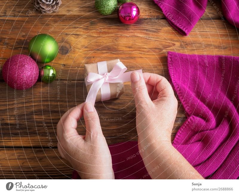 Woman with gift package in her hands Christmas & Advent Feminine Hand 1 Human being 45 - 60 years Adults Bow Gift Make Hip & trendy Anticipation Patient