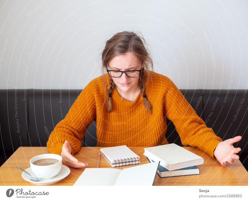 Desperate student in front of an open book Coffee Lifestyle Study University & College student Feminine Young woman Youth (Young adults) 1 Human being