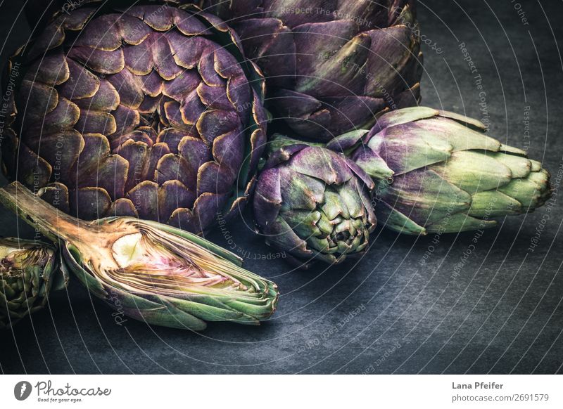 Artistic display of assorted artichokes Vegetarian diet Wallpaper Kitchen Dark Fresh Natural Artichoke background detailed in section whole Purple food healthy