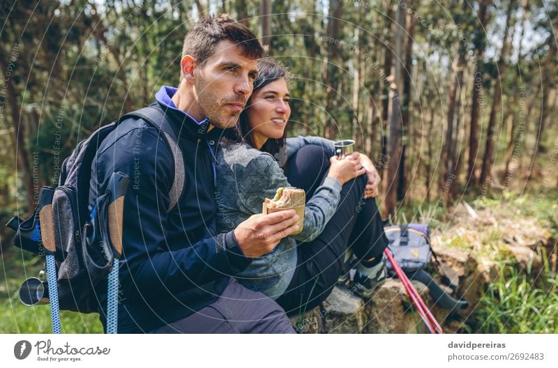 Couple pausing while doing trekking Eating Drinking Lifestyle Leisure and hobbies Adventure Mountain Hiking Sports Climbing Mountaineering Human being Woman