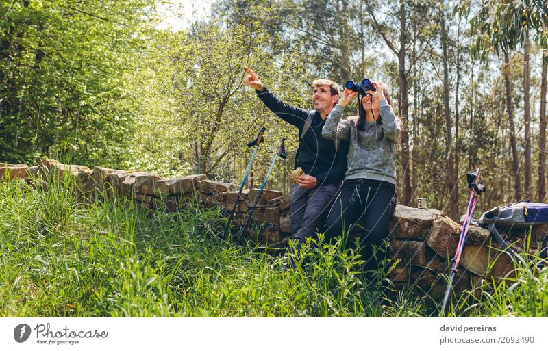 Couple doing trekking looking with binoculars Eating Lifestyle Happy Leisure and hobbies Adventure Hiking Sports Human being Woman Adults Man Nature Landscape