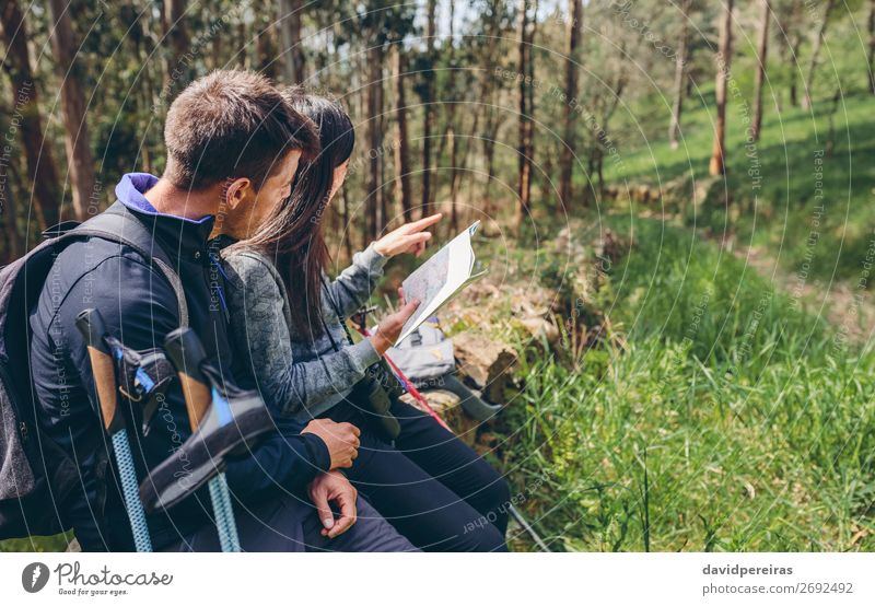 Couple doing trekking sitting looking at a map Lifestyle Trip Adventure Sightseeing Mountain Hiking Sports Human being Woman Adults Man Nature Landscape Autumn